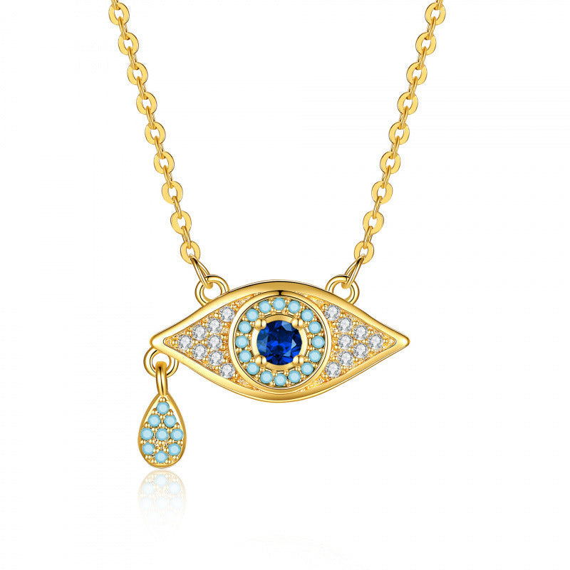 Gold-tone blue crystal evil eye pendant necklace with dangling charm