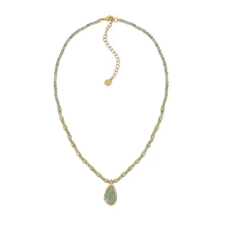 Gold tone faceted green beaded necklace with teardrop stone pendant