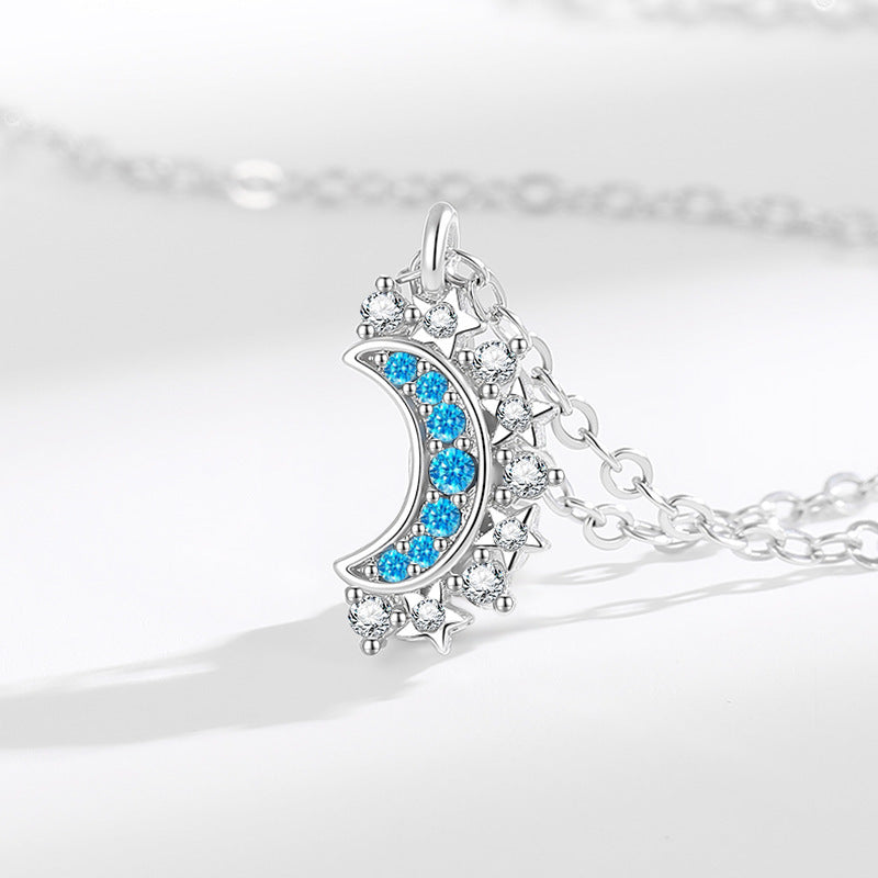 Silver-tone magnetic moon pendant necklace with blue and clear zirconia accents