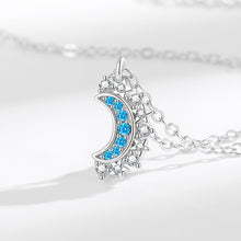 Silver-tone magnetic moon pendant necklace with blue and clear zirconia accents