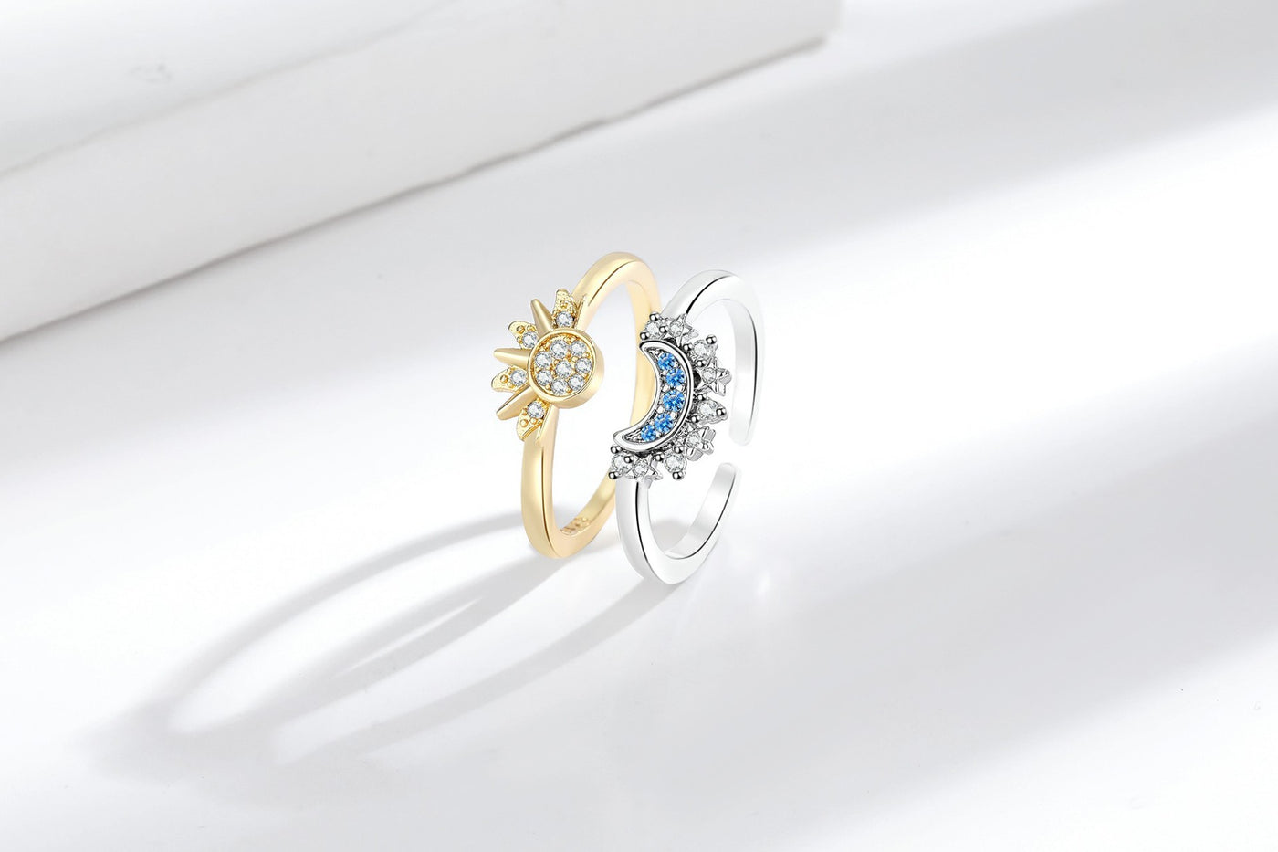 Gold-tone sun ring and silver-tone moon ring displayed side by side