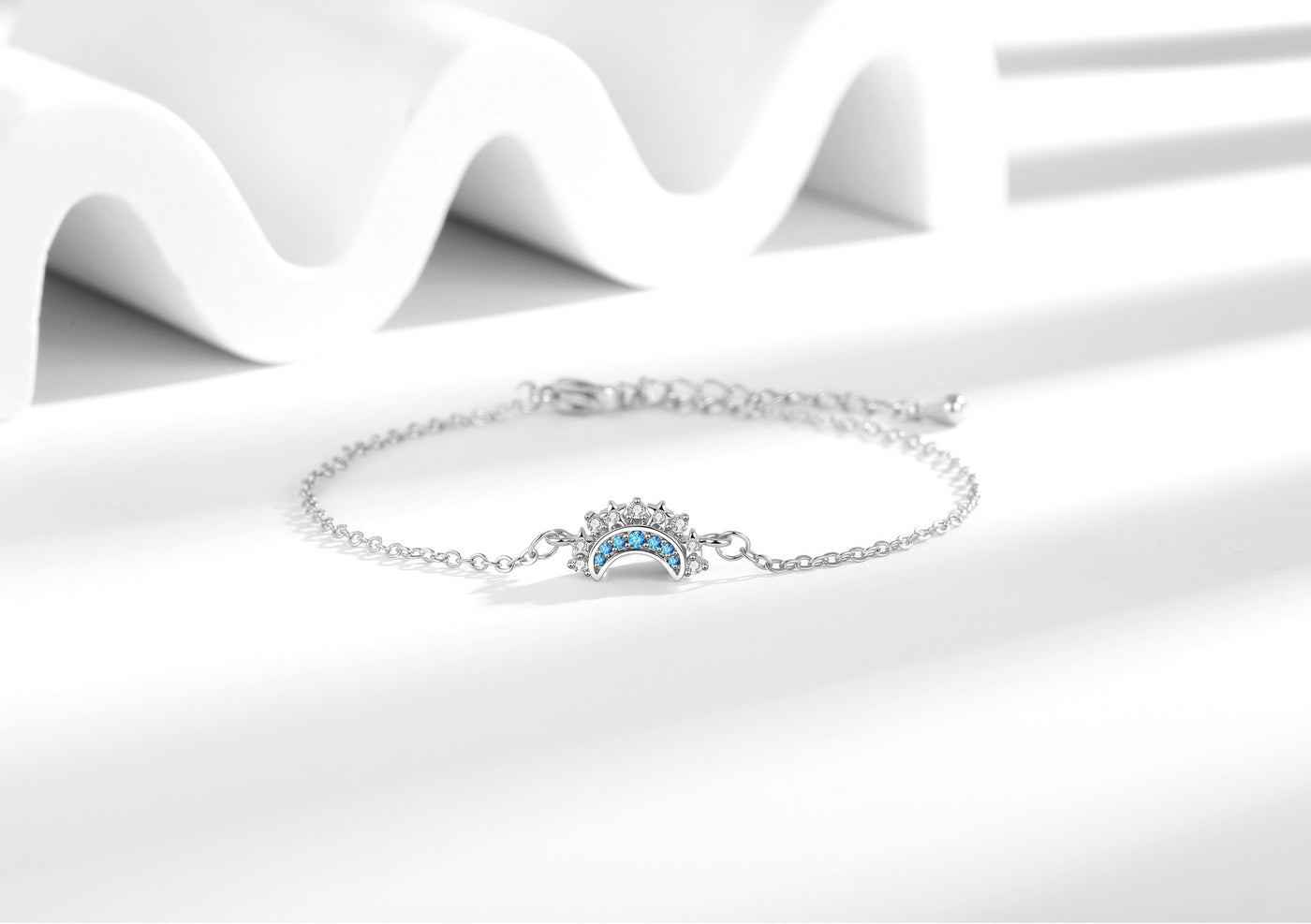 Silver-tone moon zircon bracelet with extension chain on a white background