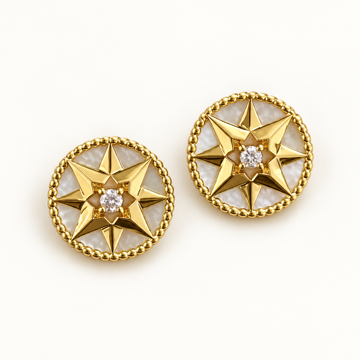 Pair of gold-tone white-inlay eight-point compass star stud earrings