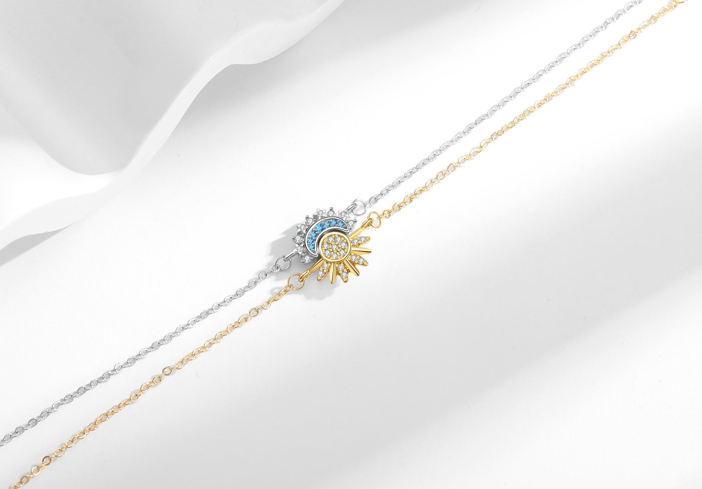 Sun and moon zircon bracelets styled together on a white background