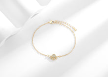 Gold-tone sun zircon bracelet with extension chain on a white background