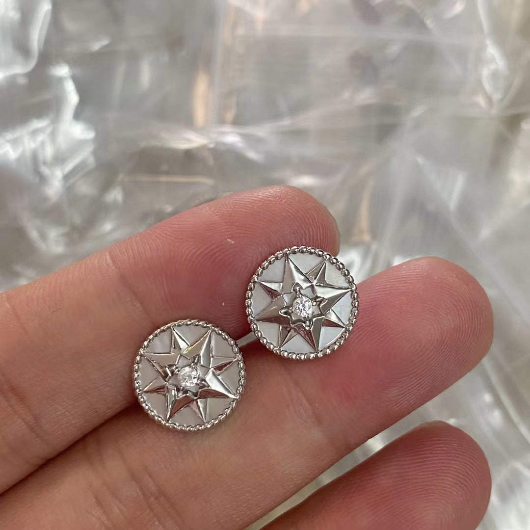 Silver-tone white-inlay eight-point star compass stud earrings with sparkling center accents