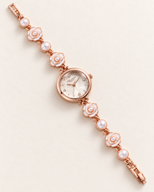 White dial SKHL bracelet watch showing layered camellia links, pearl-like accents and faceted mineral glass