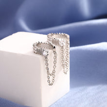Close-up of the zigzag stone band and two draped chains on silver-tone ear cuffs
