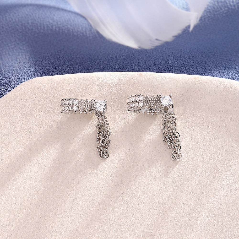 Set of two silver-tone crystal double-chain ear cuffs on a display tray