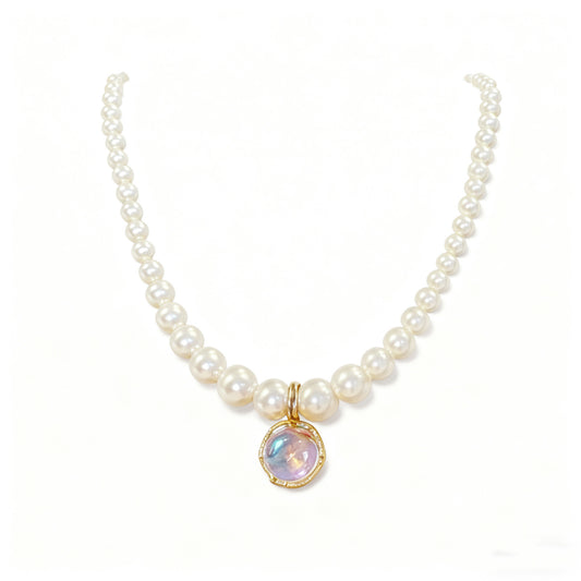 Graduated white pearl necklace with round iridescent pendant