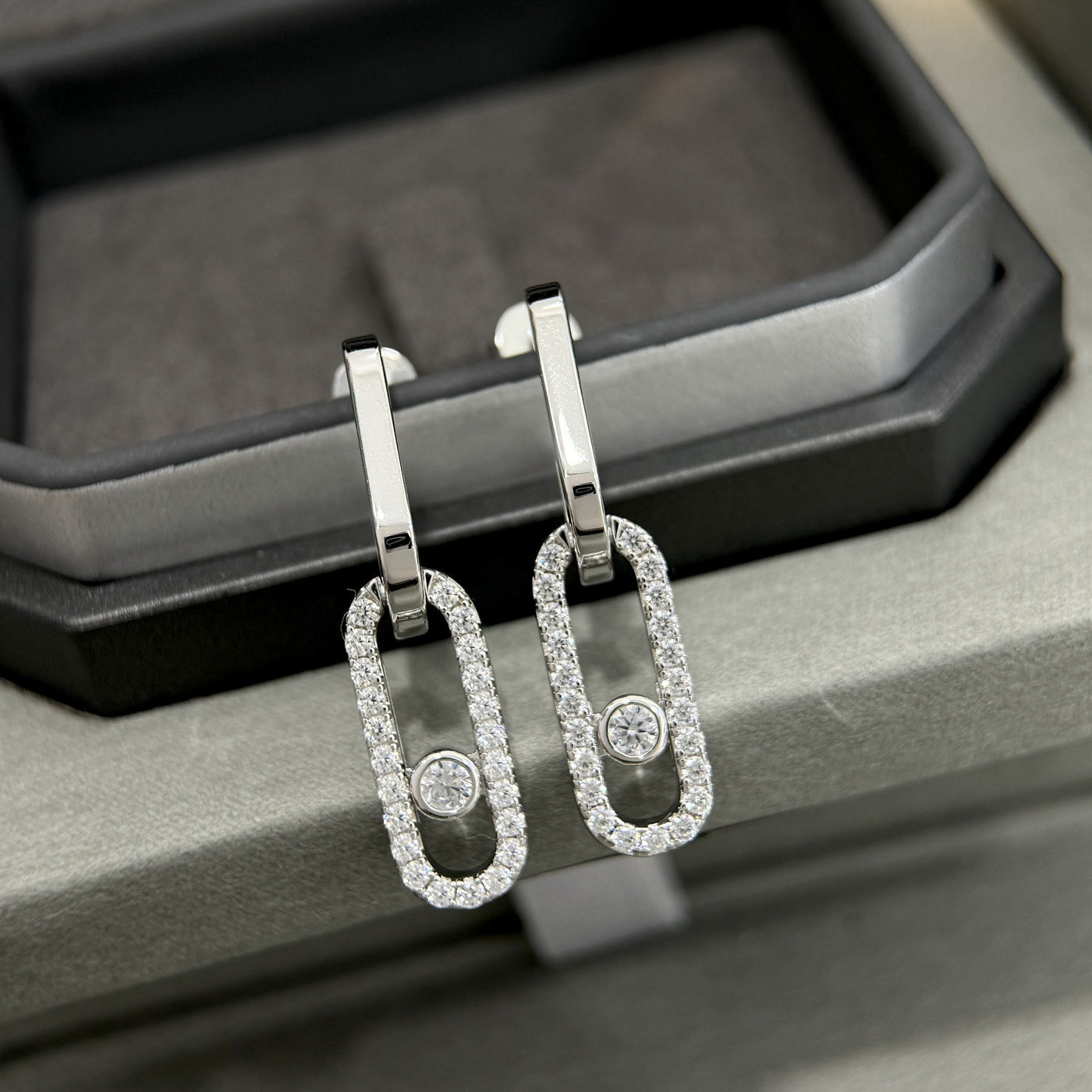 Silver-tone pavé CZ open link drop earrings displayed as a pair