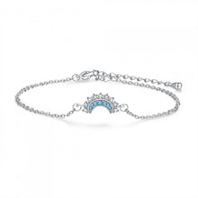Silver-tone moon motif bracelet with blue zircon accents on a white background