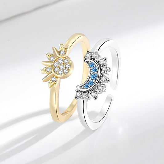 Gold-tone sun and silver-tone moon adjustable open ring pair on a white background