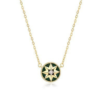 Gold-tone green-inlay eight-point star compass pendant necklace on a white background