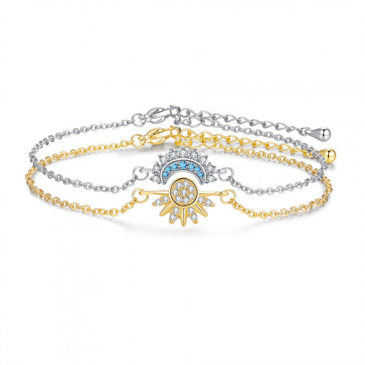 Gold-tone sun and silver-tone moon zircon bracelet set on a white background