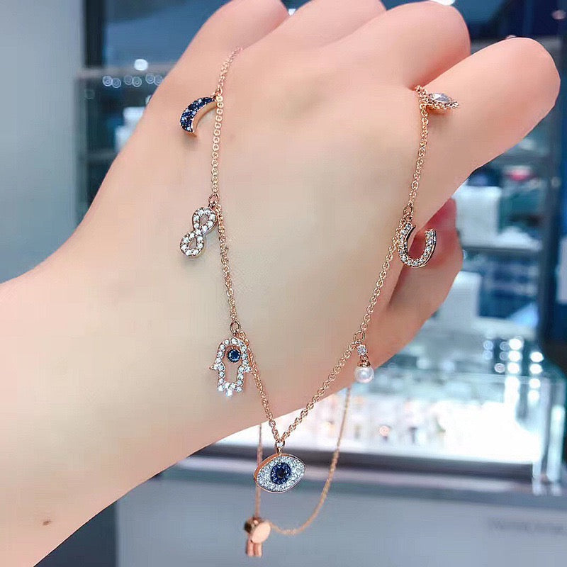 Celestial Evil Eye Multi-Charm Necklace in rose gold tone – customer supplied hand-held detail