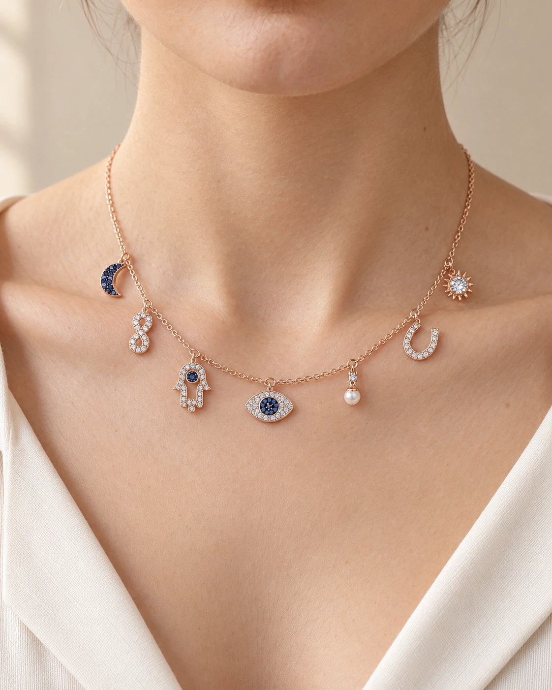 Celestial Evil Eye Multi-Charm Necklace – Rose Gold Tone on a model, seven-charm front view