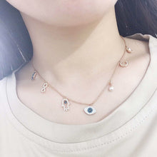 Celestial Evil Eye Multi-Charm Necklace in rose gold tone – real neckline wearing photo