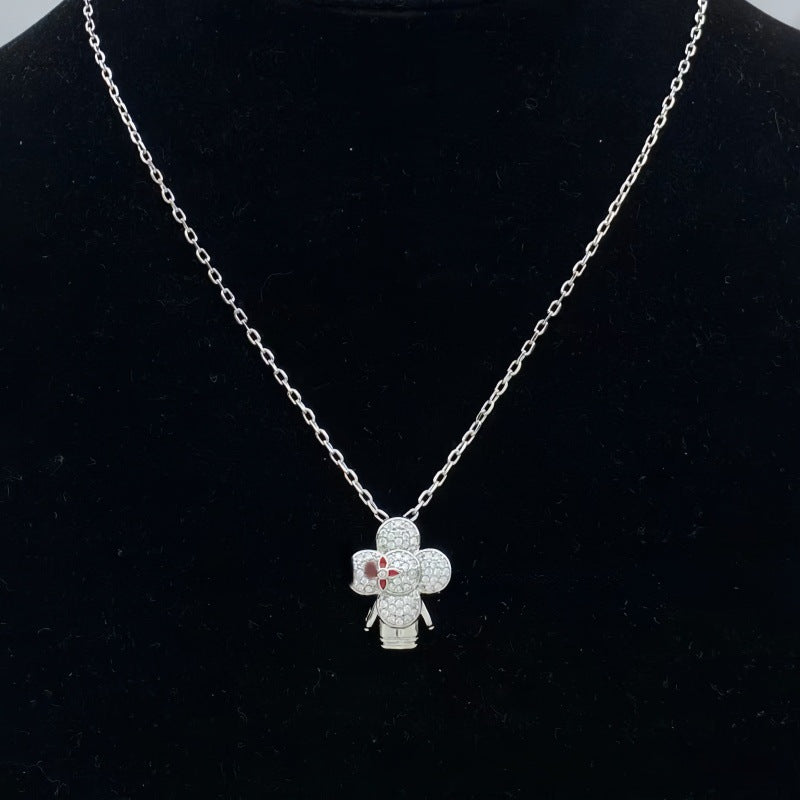 Silver-tone pave flower doll pendant necklace on a black display bust - photo 16