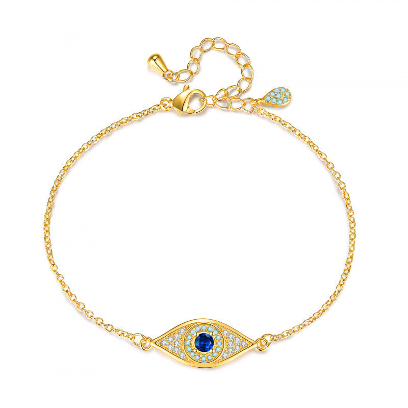 Gold tone blue crystal evil eye bracelet with adjustable extender