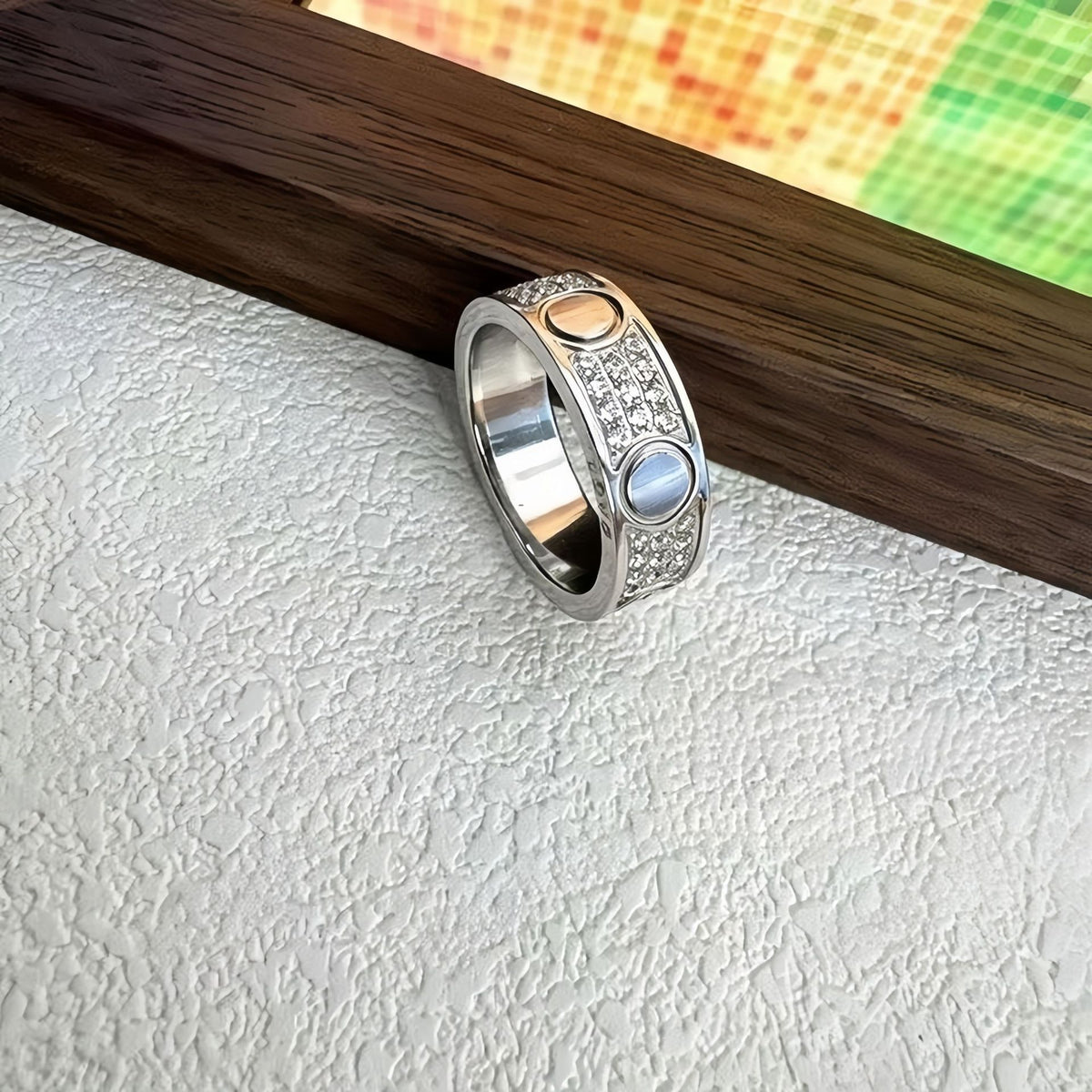 Silver-tone three-row pave circle-motif ring beside a wood display - photo 06