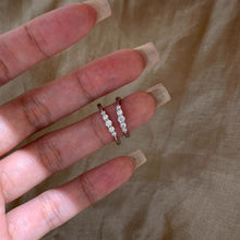 Two silver-tone five-stone pinky rings shown together
