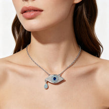 Model wearing silver tone blue crystal evil eye pendant necklace