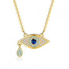 Gold tone blue crystal evil eye pendant necklace with dangling charm