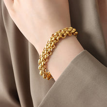 Gold tone chunky toggle chain bracelet worn on wrist