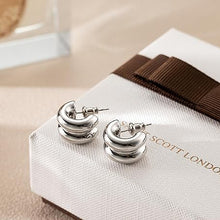 Silver tone layered C-hoop earrings detail