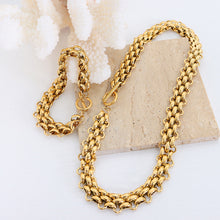 Gold tone chunky chain necklace and bracelet styled together