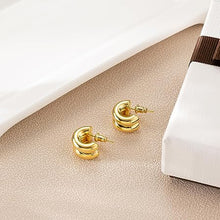 Gold tone layered C-hoop earrings detail