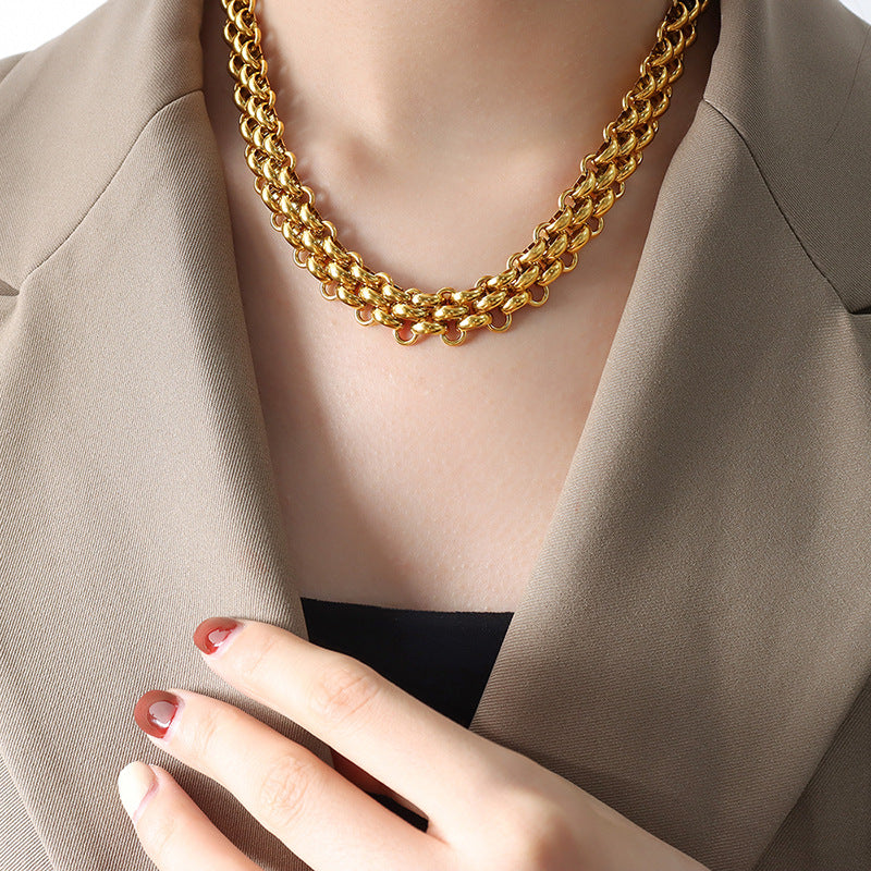 Gold tone chunky toggle chain necklace worn by woman