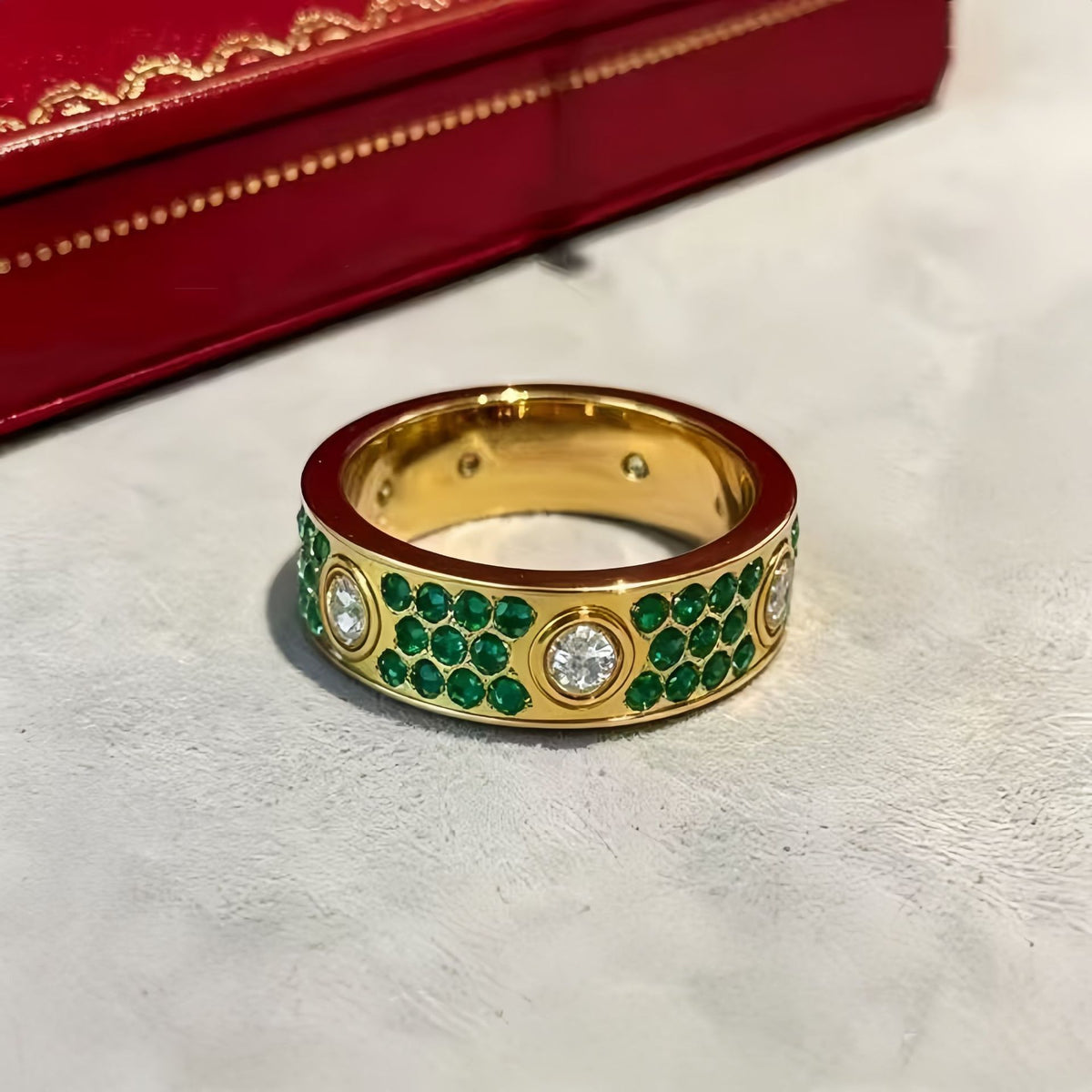Gold-tone circle-motif ring with green cubic zirconia on a light surface - photo 55