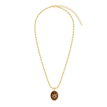 Gold tone link necklace with oval wood sun pendant and blue center stone