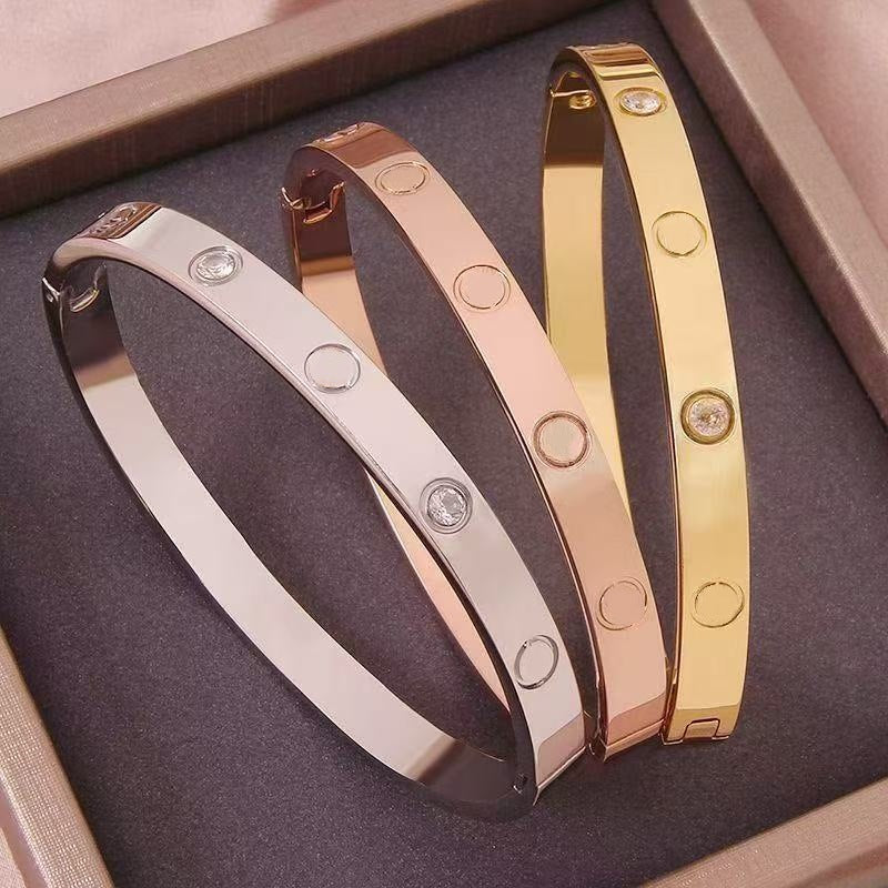 Silver, rose gold and gold tone crystal clasp bangles in a gift box