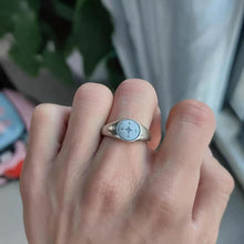 Adjustable silver tone compass signet ring worn on hand