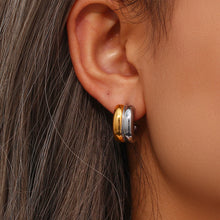Model wearing two tone stainless steel C-hoop stud earrings