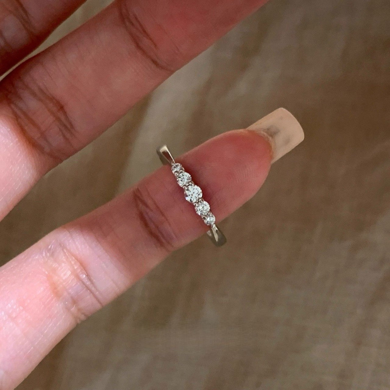 Five-stone cubic zirconia pinky ring close-up in silver tone