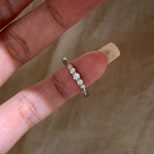 Five-stone cubic zirconia pinky ring close-up in silver tone