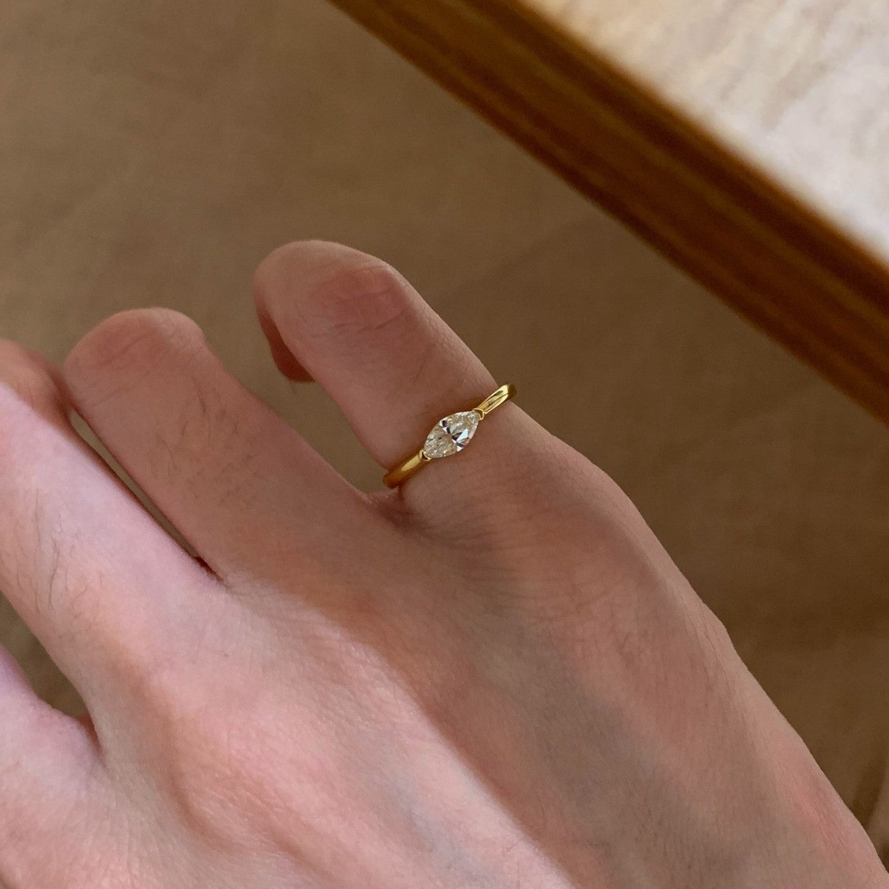 Gold-tone marquise cubic zirconia pinky ring worn on hand