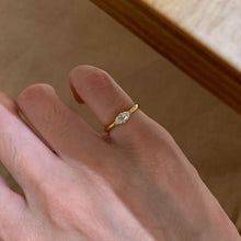 Gold-tone marquise cubic zirconia pinky ring worn on hand