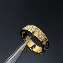 Gold-tone round-set cubic zirconia pave band ring held with tweezers - photo 16