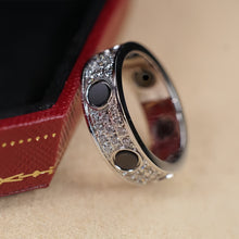 Silver-tone pave ring with black circular accents beside a box - photo 38