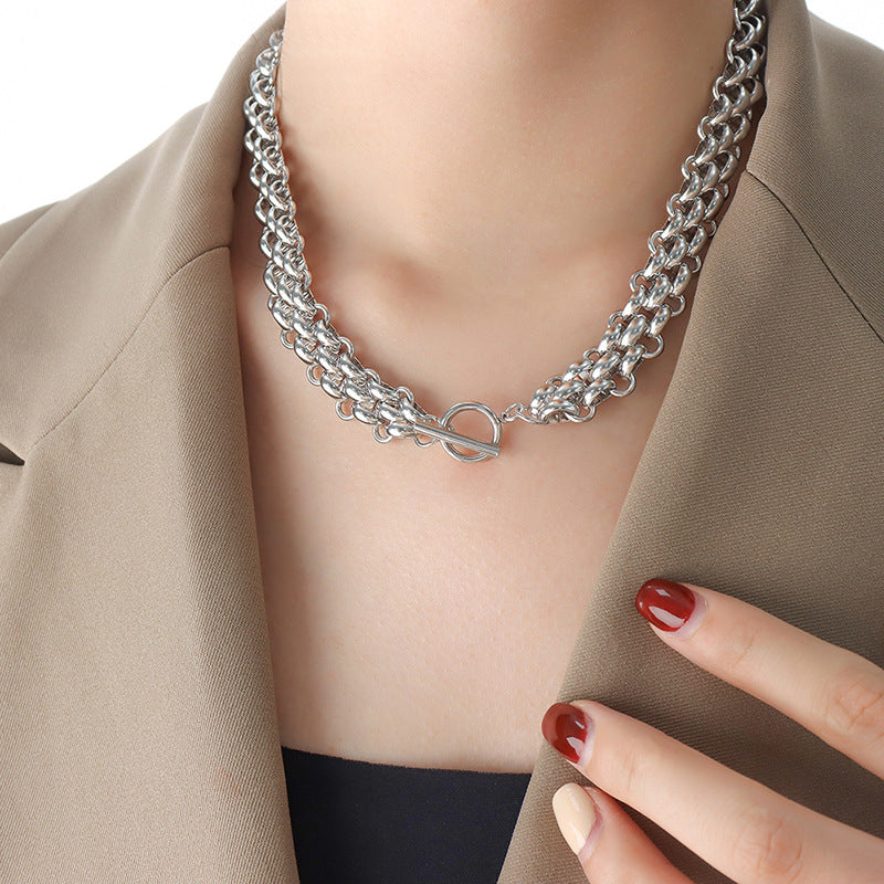 Silver tone chunky toggle chain necklace worn by woman