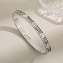 Gold tone pave screw motif bangle close-up