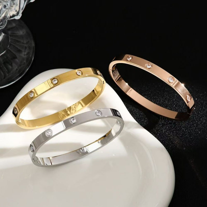 Gold, silver and rose gold tone cubic zirconia hinged bangles