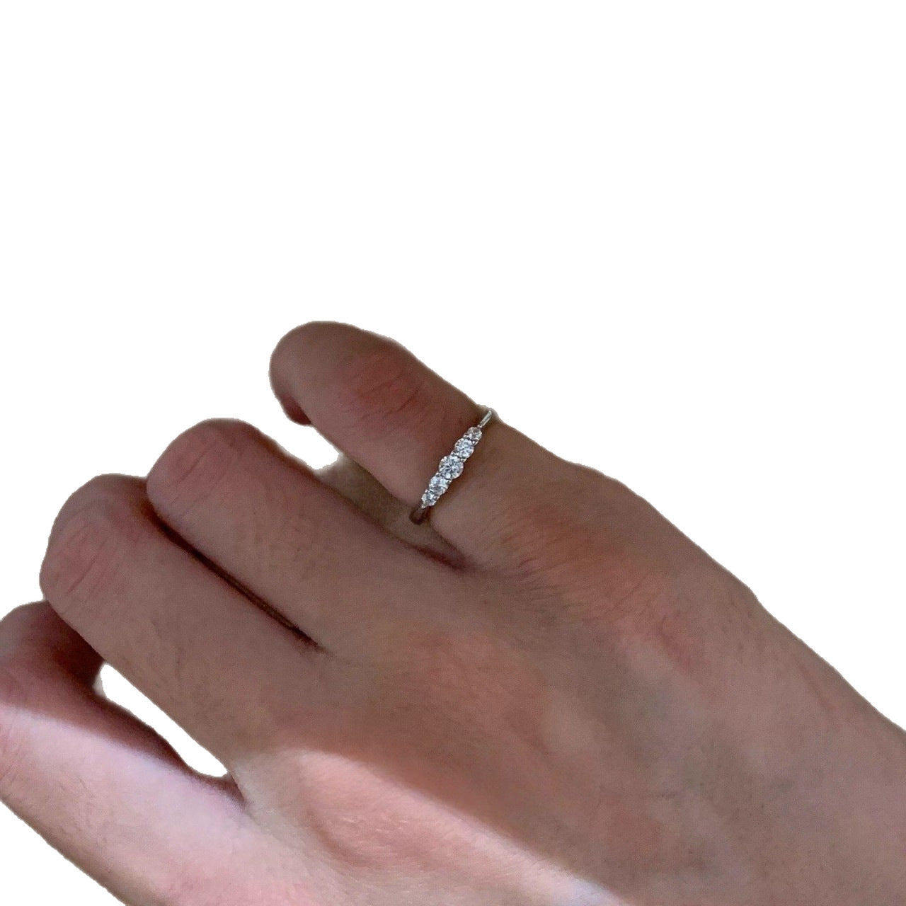 Five-stone silver-tone pinky ring worn against a white background