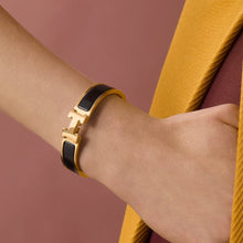 H Signature Bangle – Gold and Black, worn on wrist