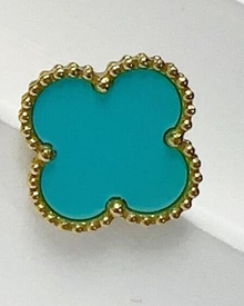 Close-up of an Aqua Blue four-leaf clover stud showing its colored center and gold-tone beaded border.